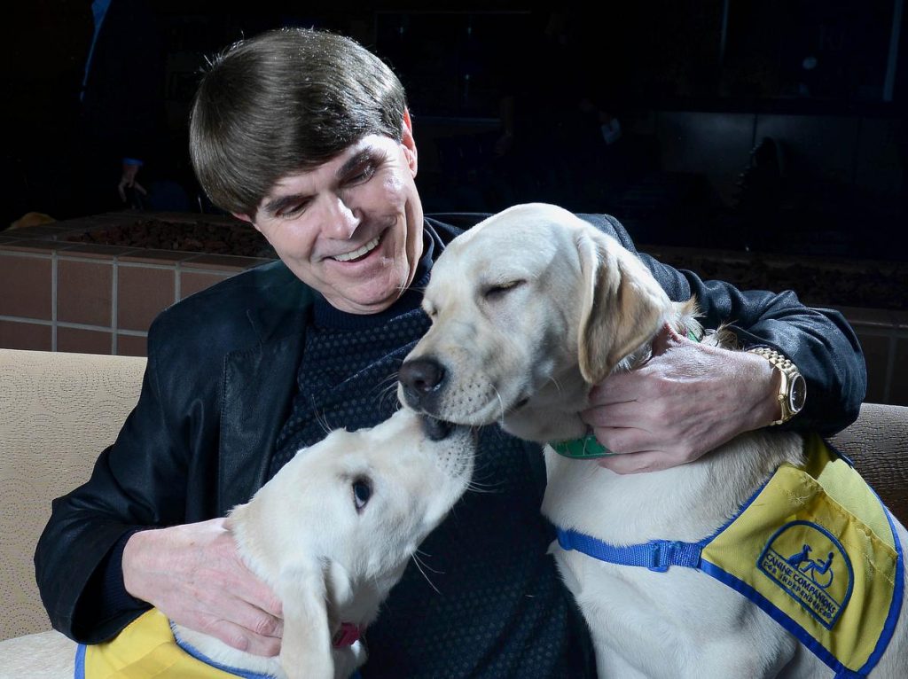 Author Dean Koontz played with two dogs from the Canine Companions for Independence program when he visited the Orange County Register Thursday. The puppy on the left is named Lyric IV. On the right is Deedee. ///ADDITIONAL INFORMATION: 1/14/16 - koontz.0115 - BILL ALKOFER, STAFF PHOTOGRAPHER - Dean Koontz was the most recent author to visit the Orange County Register Book Club. He visited the newspaper on Thursday